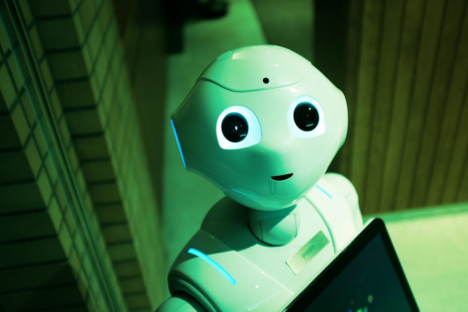 A robotic hand reaching into a digital network on a blue background, symbolizing AI technology.